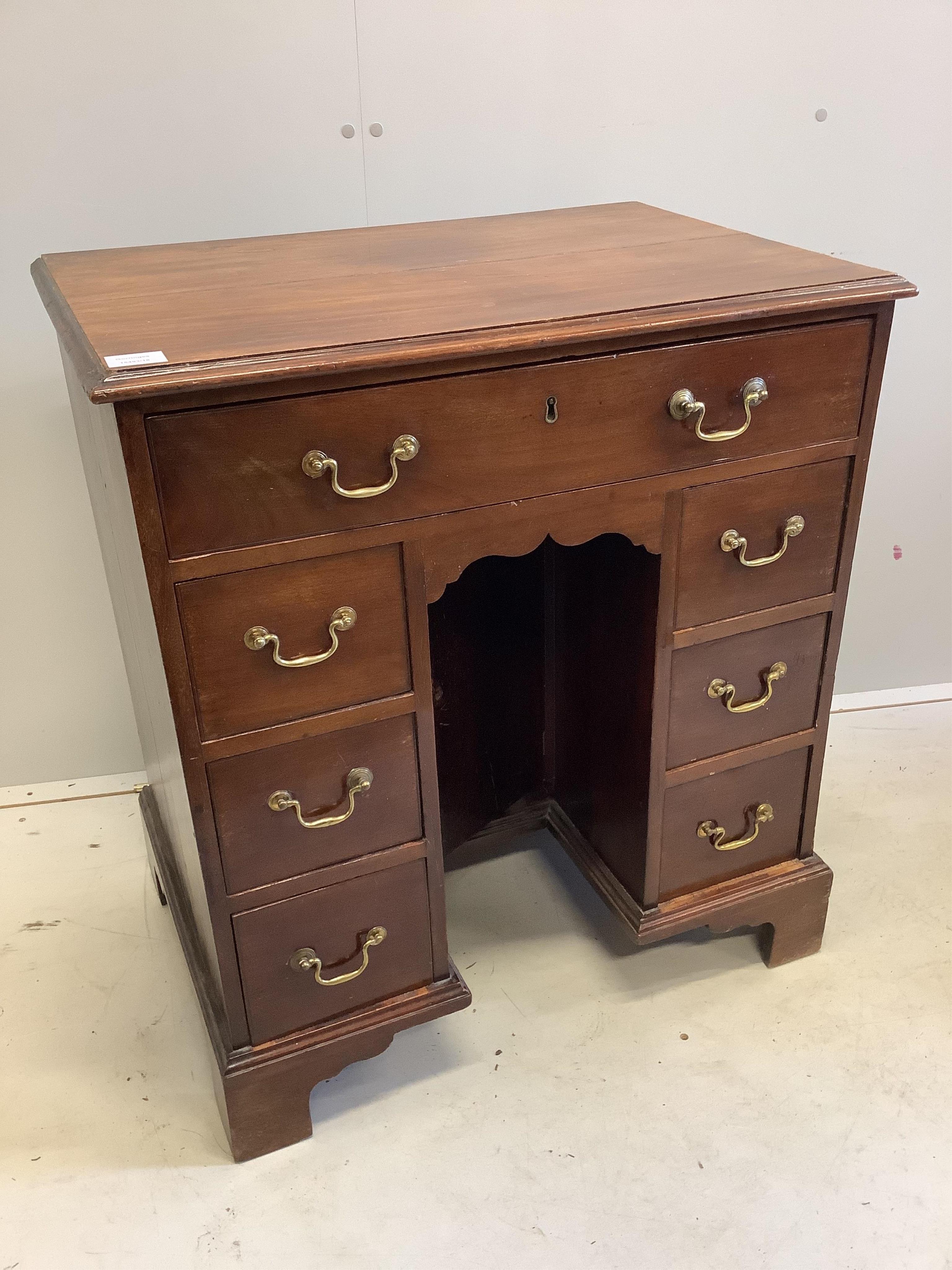 A George III mahogany kneehole desk, width 71cm, depth 48cm, height 80cm. Condition - fair to good